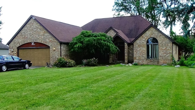 7407 Beecher Rd, Flint, MI 48532 - view of front of home featuring a front yard, brick siding, and an attached garage