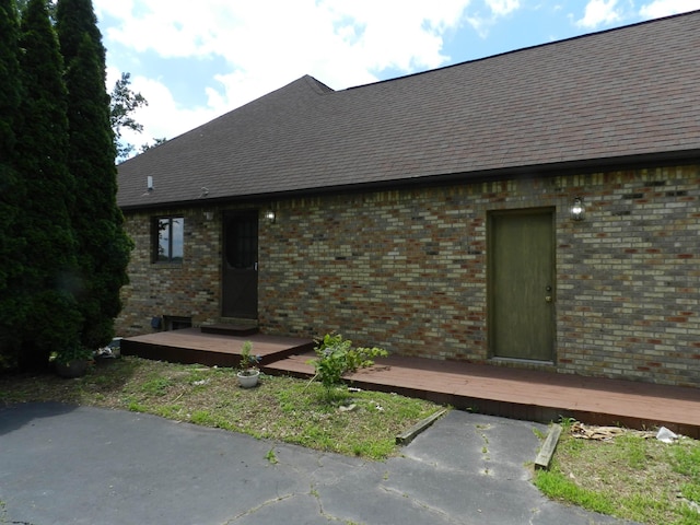 7407 Beecher Rd, Flint, MI 48532 - view of side of property with a wooden deck and brick siding