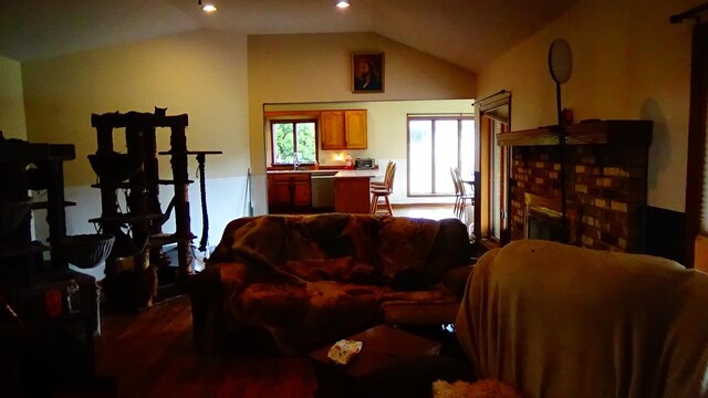 7407 Beecher Rd, Flint, MI 48532 - living room with dark wood-style floors, lofted ceiling, and a fireplace