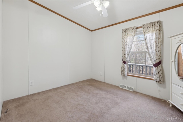 unfurnished room with visible vents, carpet flooring, ceiling fan, and ornamental molding
