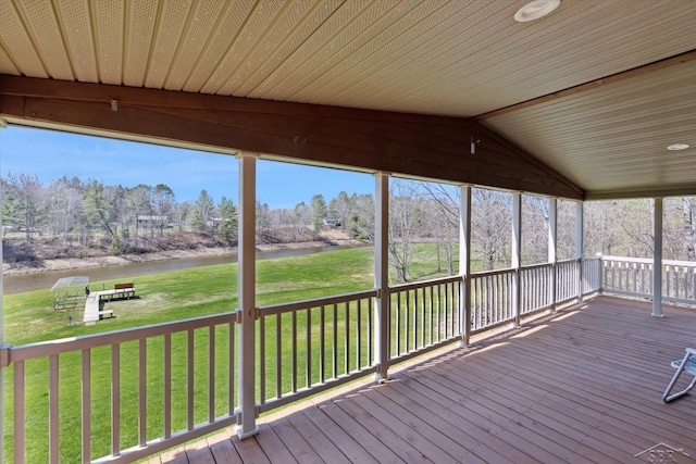 deck featuring a lawn and a water view