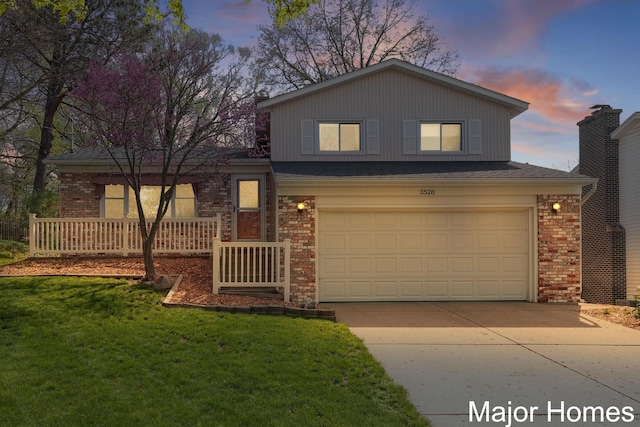 view of front of house featuring an attached garage, a front lawn, brick siding, a porch, and concrete driveway