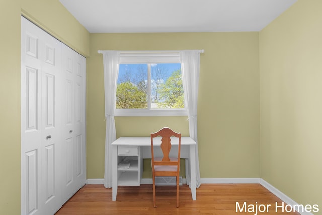office area with baseboards and wood finished floors