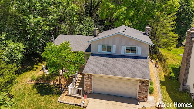 view of front of home with a chimney, brick siding, a shingled roof, driveway, and stairway
