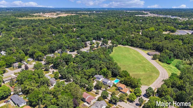 drone / aerial view featuring a forest view