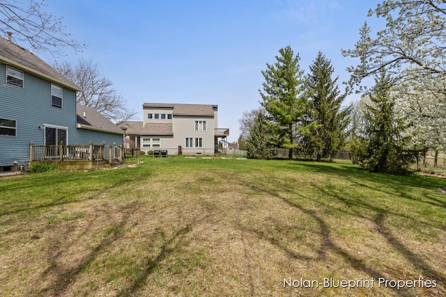 view of yard with fence and a wooden deck