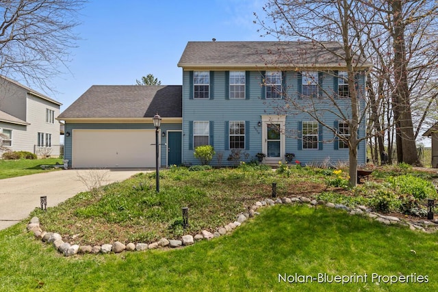 colonial house with concrete driveway, a front yard, and a garage