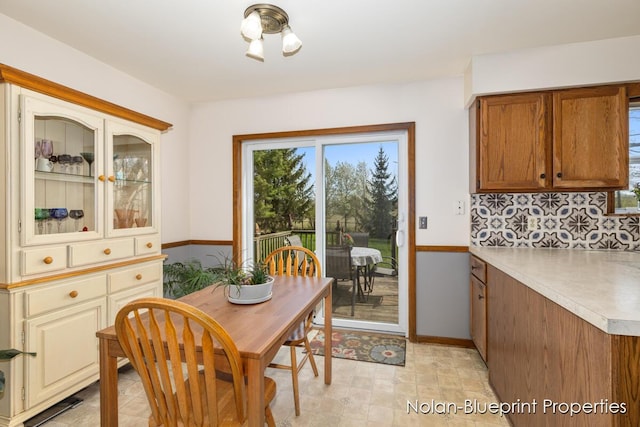 dining room with baseboards and plenty of natural light