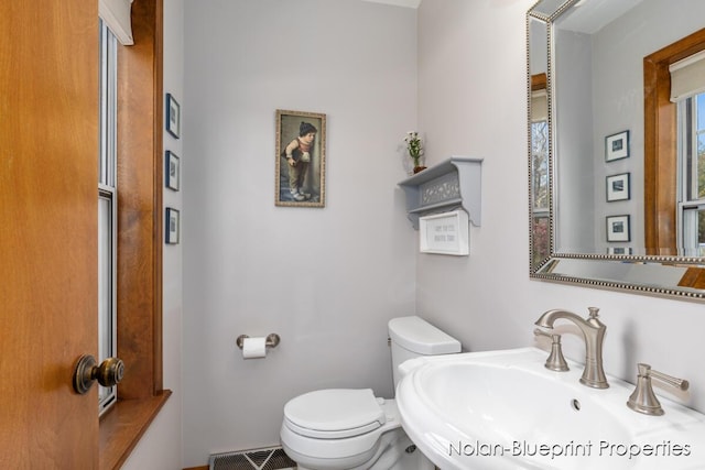 bathroom featuring toilet and a sink
