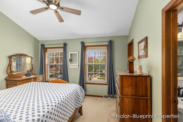 bedroom with a ceiling fan, visible vents, light colored carpet, baseboards, and lofted ceiling