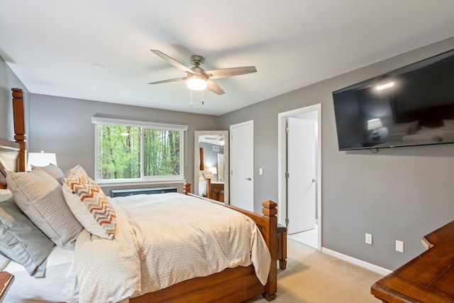 bedroom featuring baseboards, ceiling fan, and light colored carpet