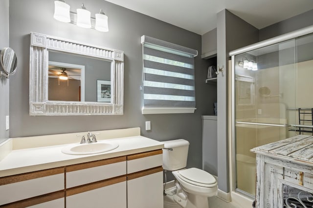 bathroom with vanity, toilet, tile patterned floors, a ceiling fan, and a stall shower