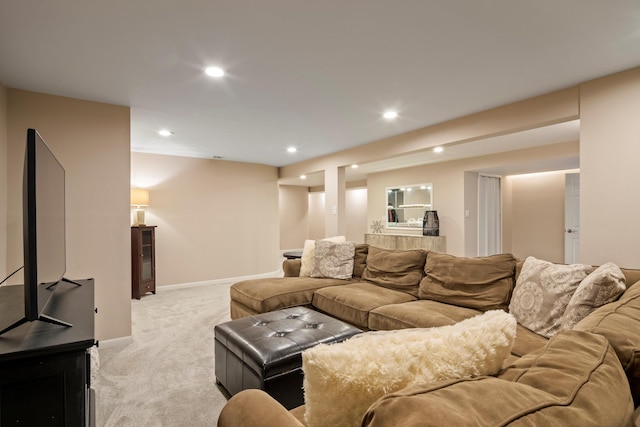 living area with baseboards, recessed lighting, and light carpet