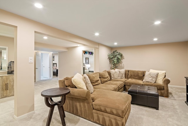living room with recessed lighting, baseboards, and light colored carpet
