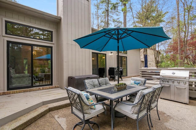 view of patio featuring grilling area, a deck, and outdoor dining space