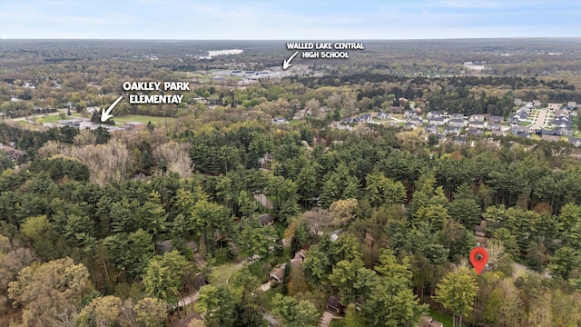 drone / aerial view featuring a view of trees