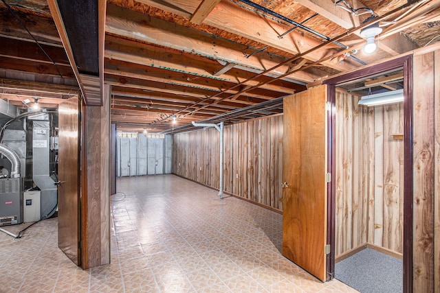 basement featuring tile patterned floors and heating unit
