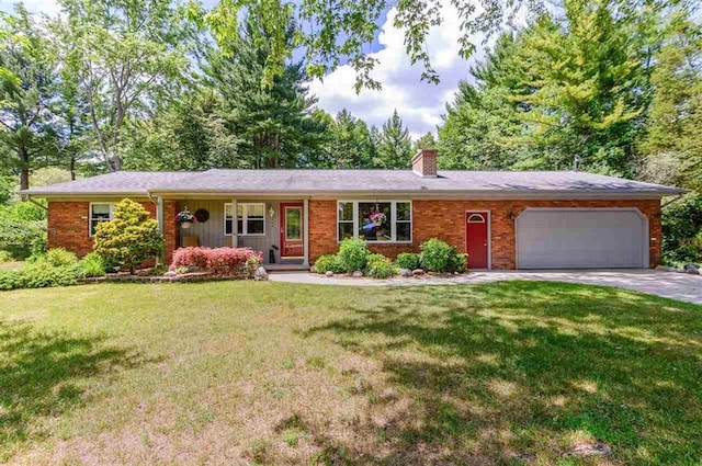 ranch-style house with brick siding, a garage, a front yard, a chimney, and driveway