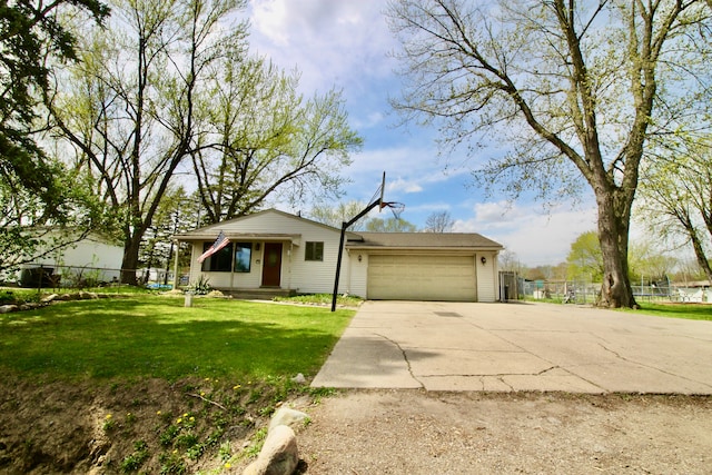 view of front of house with fence, driveway, a front lawn, and a garage
