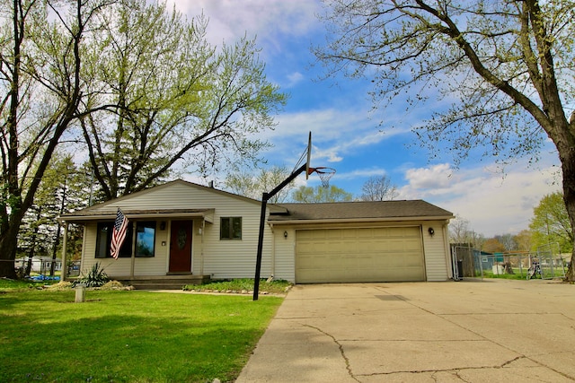 view of front of property with concrete driveway, an attached garage, fence, and a front yard