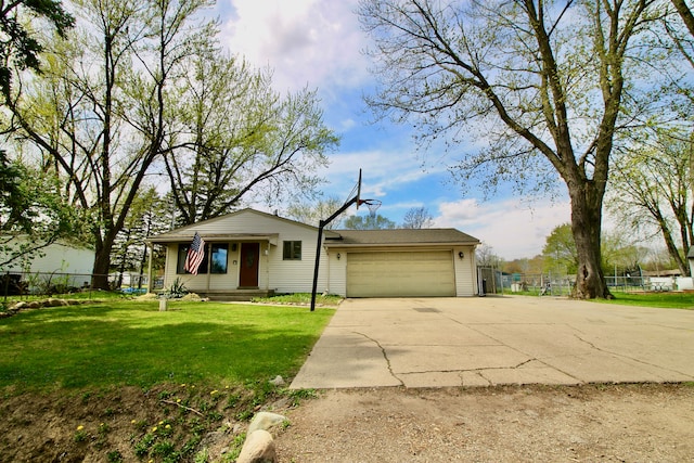 view of front of home with fence, an attached garage, concrete driveway, and a front yard