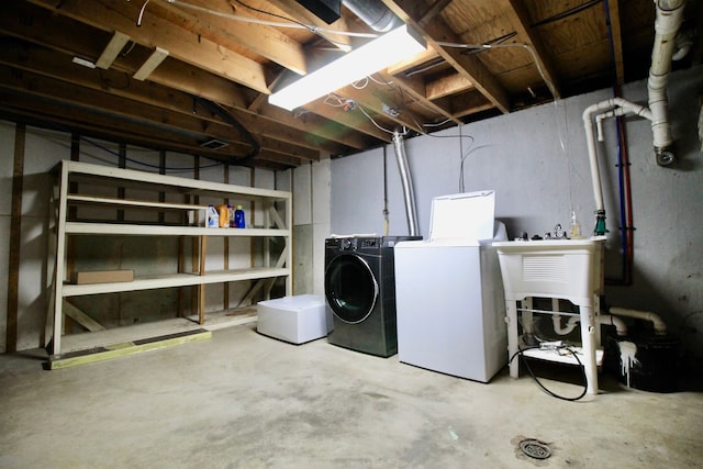 unfinished below grade area featuring independent washer and dryer