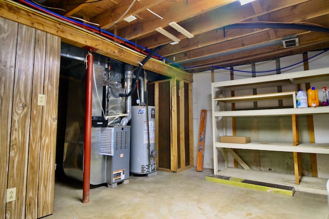 unfinished below grade area featuring visible vents, heating unit, and gas water heater