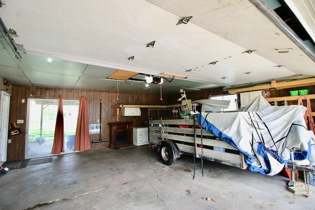garage featuring a garage door opener and wood walls