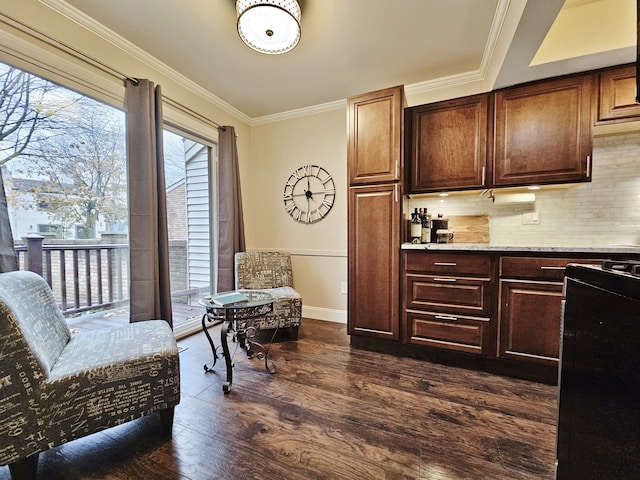 interior space featuring black gas range, ornamental molding, dark wood-style flooring, decorative backsplash, and baseboards