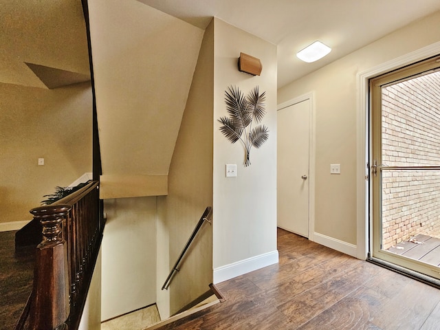 foyer entrance with baseboards and wood finished floors