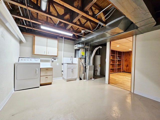 unfinished basement with baseboards, washer / dryer, heating unit, and gas water heater