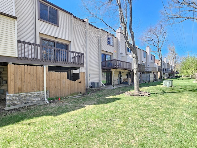 view of yard with central AC and a residential view