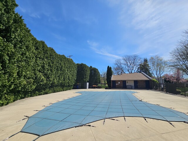 pool featuring fence and a patio