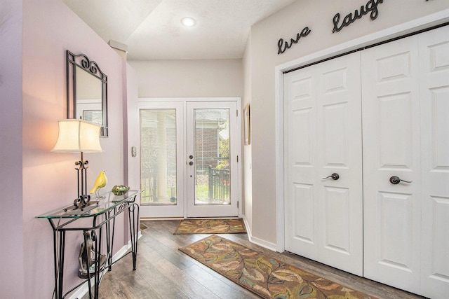 entryway with recessed lighting, baseboards, wood finished floors, and french doors