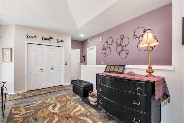 interior space with visible vents, a closet, wood finished floors, baseboards, and recessed lighting