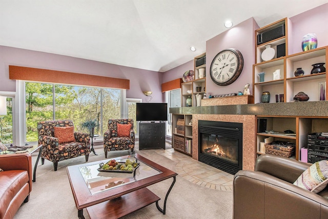 living room with light colored carpet, vaulted ceiling, and a fireplace