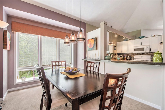 dining room featuring baseboards, light carpet, vaulted ceiling, and a notable chandelier