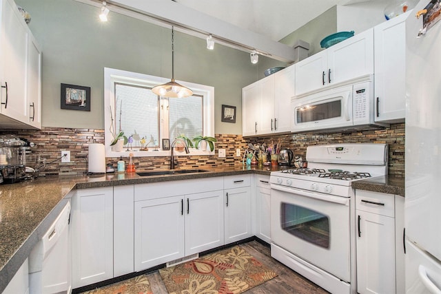 kitchen featuring visible vents, a sink, white cabinetry, and white appliances