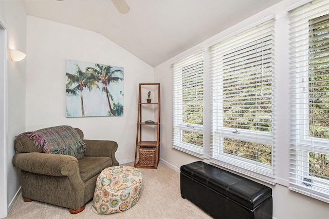 sitting room featuring carpet floors, baseboards, and lofted ceiling