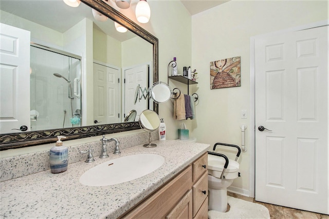 bathroom featuring toilet, a shower stall, tile patterned flooring, and vanity