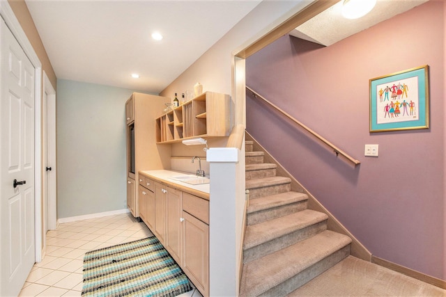 stairway with recessed lighting, baseboards, and tile patterned flooring