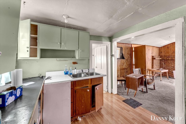 114 E St, Coopersville, MI 49404 - kitchen featuring wooden walls, open shelves, a sink, light wood-style flooring, and green cabinets