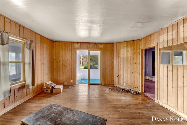 114 E St, Coopersville, MI 49404 - unfurnished room featuring baseboards, wood-type flooring, and wood walls