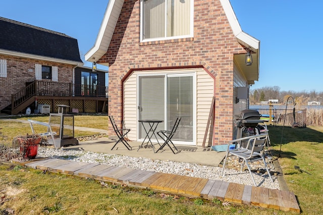 61342 Lewis Lake Rd, Vandalia, MI 49095 - back of house featuring a yard, brick siding, a wooden deck, and a patio