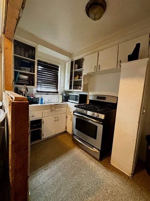 kitchen featuring white cabinets, open shelves, and stainless steel appliances