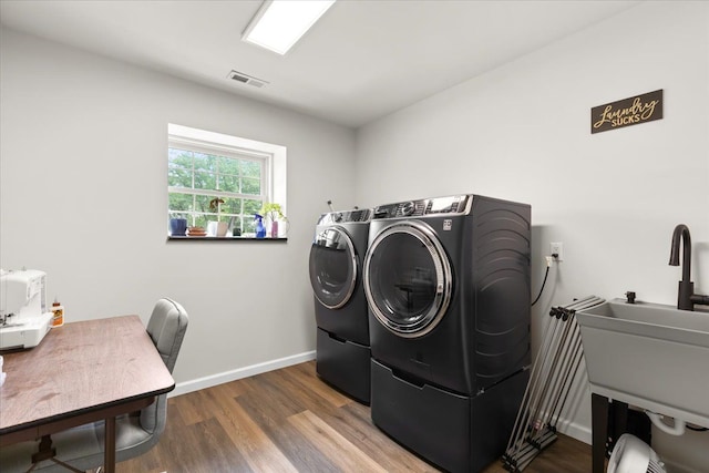 114 Bernstadt St, Novi, MI 48377 - washroom featuring visible vents, laundry area, wood finished floors, separate washer and dryer, and a sink