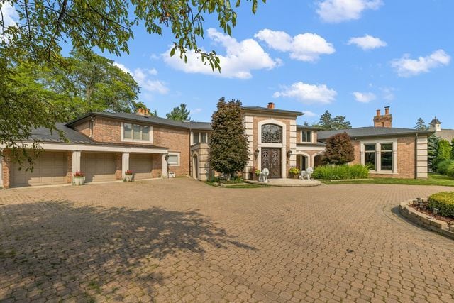 362 Keswick Rd, Bloomfield Hills, MI 48304 - mediterranean / spanish home with curved driveway, an attached garage, and brick siding