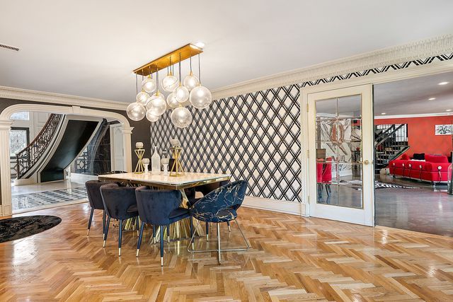 362 Keswick Rd, Bloomfield Hills, MI 48304 - dining space with crown molding, arched walkways, visible vents, and stairway