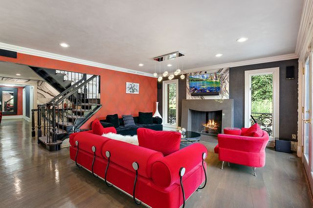 362 Keswick Rd, Bloomfield Hills, MI 48304 - living area with ornamental molding, stairs, wood finished floors, a warm lit fireplace, and recessed lighting
