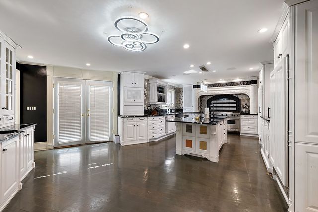 362 Keswick Rd, Bloomfield Hills, MI 48304 - kitchen with visible vents, glass insert cabinets, a center island, recessed lighting, and white cabinetry